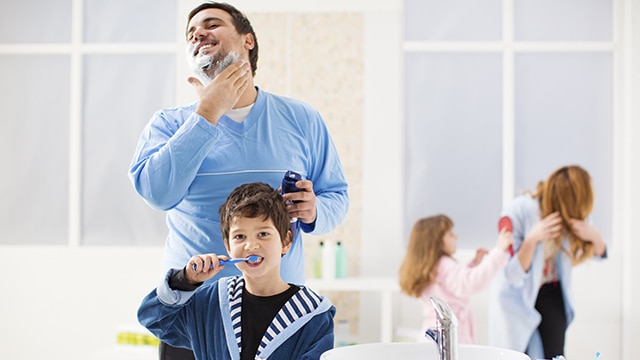 dad and son brushing their teeth