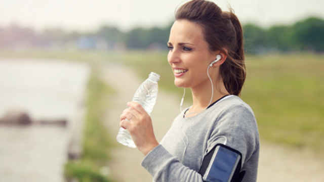 Woman working out and drinking water