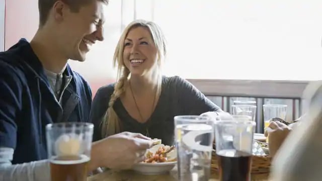 Couple in restaurant laughing at a joke