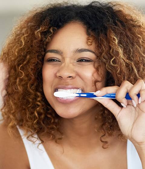 girl brushing her teeth