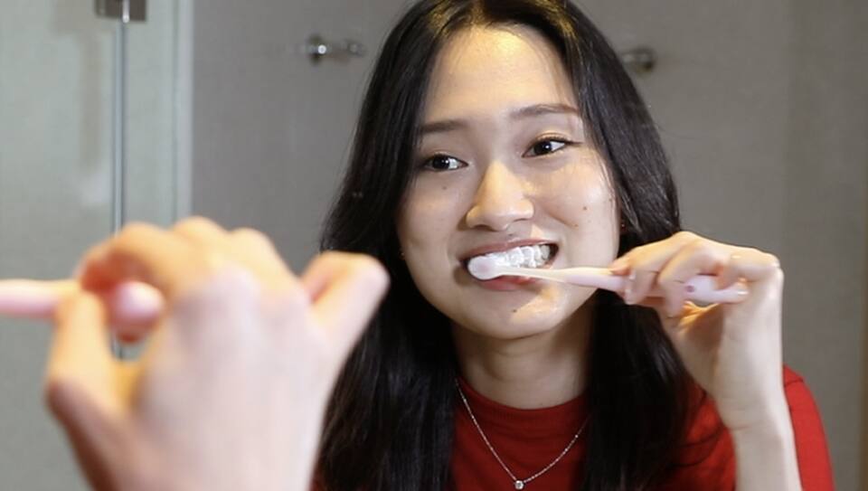 Lady brushing her teeth after serum Lady brushing her teeth after serum