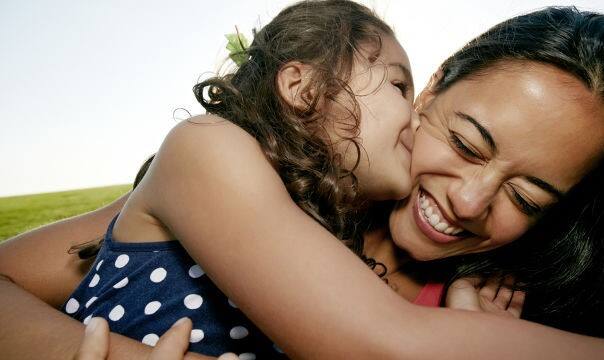 daughter kissing mum on cheek