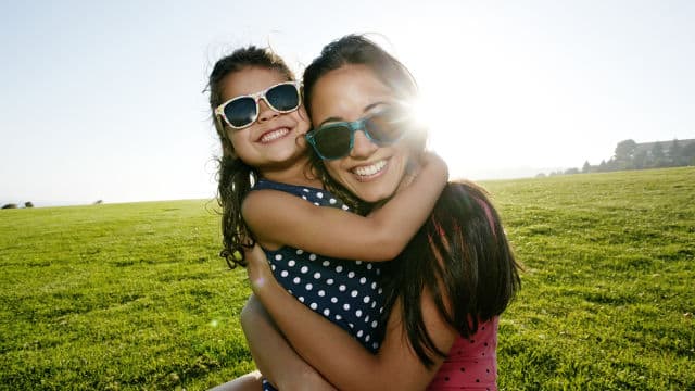mother and daughter outdoors smiling