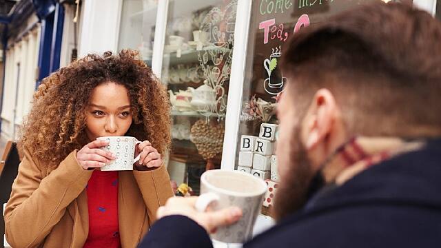 man and woman having tea