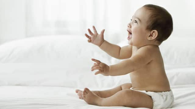 a baby is smiling after natural teething remedies 