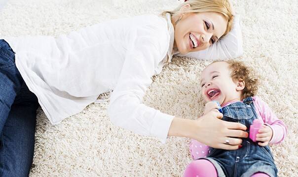 mom and daughter smiling