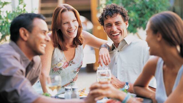 A group of friends are smiling with good teeth because of proper flossing