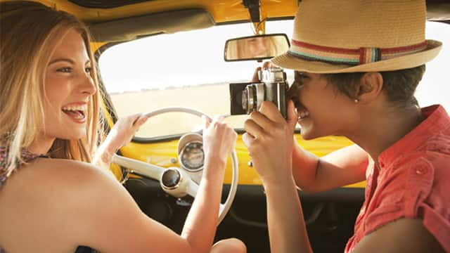 smiling woman behind steering wheel