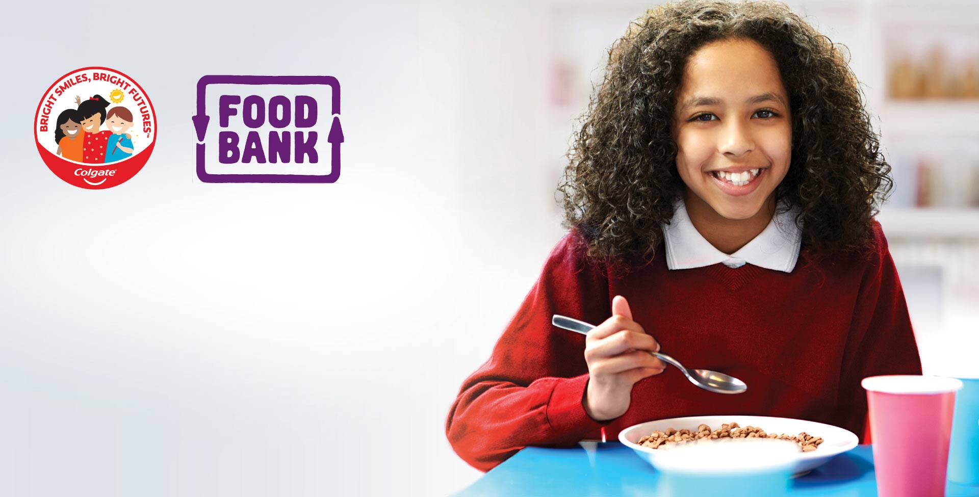 Kid smiling while she eats her breakfast